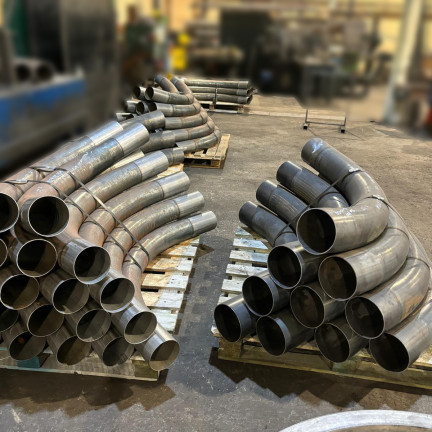 Induction Bending three piles of round pipes on the pallets 